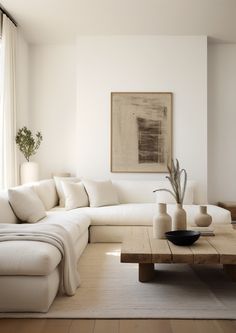 a living room filled with furniture and a large painting on the wall above the couch