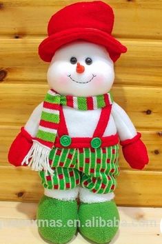 a stuffed snowman wearing green and red pants