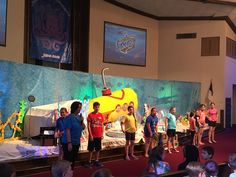 children are standing on stage in front of an audience at a school event with dr seuss