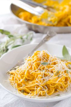 a white plate topped with pasta and cheese