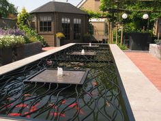 a large pond filled with lots of water and goldfish swimming in it's sides