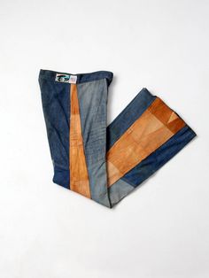 two pieces of denim and wood sitting on top of each other in front of a white background