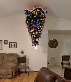 a living room filled with furniture covered in christmas lights and decorations on the wall above it