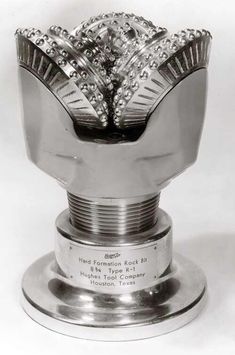 a silver trophy sitting on top of a metal base