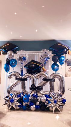 the balloons are in the shape of numbers and graduation caps