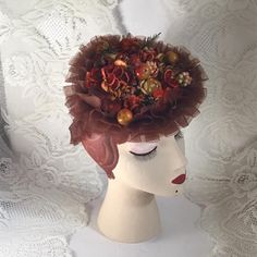 "Vintage 1940's hat. Deep Copper color ruffles with a ringlet in back to help keep the hat in place when worn. Is adorned on the top with fruit (possibly apples), flowers and greens in autumn colors. The hat reminds me of a box of candy. The maker is *Martha Todd* Newark.  *SCROLL DOWN FOR CONDITION & MEASUREMENTS* CONDITION: No issues noted. MEASURES: Front to back~7\" Left to right~7 1/2\" *WE APOLOGIZE~BUT WE CAN NO LONGER SHIP TO GERMANY, ITALY OR SPAIN. IF ORDERS COME IN FROM GERMANY, ITALY OR SPAIN, WE WILL HAVE TO CANCEL THEM AND REFUND YOUR MONEY. SORRY FOR THIS INCONVENIENCE*" 1930s Hat With Faux Fruit, Vintage Cloche Hat For Vintage Events, Vintage Fitted Cloche Headpiece, Vintage Cloche Costume Hat For Vintage Events, Vintage Headpieces For Kentucky Derby, Vintage Short Brim Fascinator For Garden Party, Vintage Fascinator With Curved Brim For Garden Party, Vintage Fitted Headpiece For Kentucky Derby, Vintage Fitted Headpiece With Short Brim