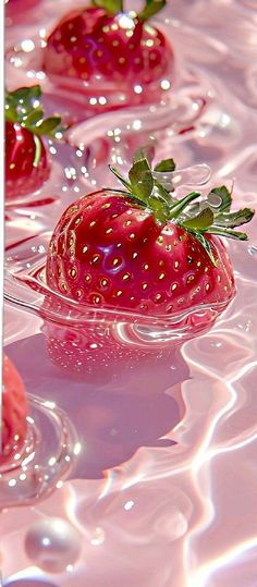 several strawberries floating in the water on top of each other