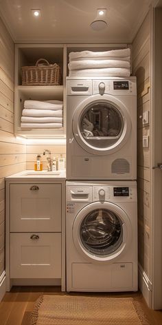 a washer and dryer in a small room with wooden flooring, built - in shelving