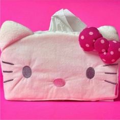 a pink hello kitty purse with a bow on it's head and polka dots