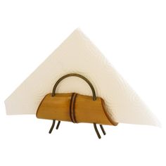 a napkin holder with a wooden handle and two white napkins hanging from it's sides