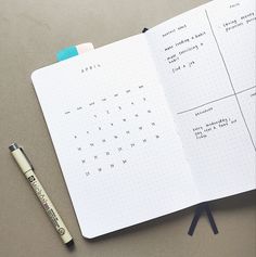 an open planner with a pen on it