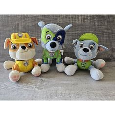 three stuffed animals sitting next to each other