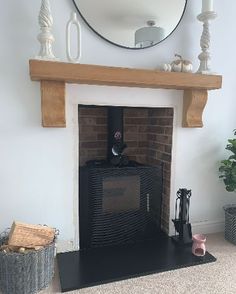 a living room with a fireplace and mirror