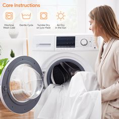 a woman is looking at the washing machine