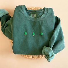 Cozy up with our Comfort Colors Christmas Trees Sweatshirt this winter season! The perfect gift for any Christmas Trees and Christmas season lovers out there! - Our sweatshirt material is super soft and high quality! ♡ - Garment-Dyed Sweatshirt (Sustainable style)  - 80% cotton, 20% polyester - All our sweatshirts run a UNISEX fit. (Both for men and women) They fit true to size. But if you like a more baggy look, we highly recommend sizing up. - These letters are embroidered iron-on patches that Matching Christmas Sweatshirts, Christmas Cotton Long Sleeve Sweater, Cozy Green Crew Neck Top, Green Cozy Crew Neck Top, Casual Cotton Christmas Sweatshirt, Casual Christmas Cotton Sweatshirt, Green Cotton Christmas Tops, Casual Christmas Crew Sweatshirt, Casual Christmas Crew Neck Sweatshirt