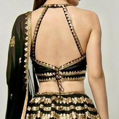 Get ready to make a stylish statement with this jaw-dropping Black and Gold Sequinned Lehenga Set. The exquisite gold hand embroidery on the black ebony base adds a touch of opulence. The silk blouse with a halter neckline and crisscross details at the back adds a modern twist. Complete the look with the georgette dupatta featuring delicate floral motifs. Customizable in any color of your choice. Composition: Lehenga and Blouse - Raw Silk , Dupatta - Georgette All products can be customised for Black Embellished Sharara For Diwali, Bollywood Style Embellished Black Sharara, Elegant Kundan Choli For Party, Semi-stitched Embellished Black Sharara, Black Cutdana Blouse For Reception, Embellished Semi-stitched Black Sharara, Black Embellished Blouse With Traditional Drape, Embellished Black Traditional Wear For Navratri, Black Traditional Wear With Mirror Work For Evening