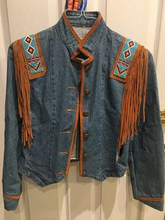 Small size but fits as S/M Denim western/ country style jacket.  Beaded with leather fringe Metal buttons. Medium Wash Outerwear For Rodeo In Fall, Fringe Denim Jacket For Fall Festival, Bohemian Denim Jacket With Fringe For Fall, Western Style Medium Wash Outerwear For Spring, Western Style Long Sleeve Denim Jacket For Fall, Fall Festival Denim Jacket With Fringe, Western Style Long Sleeve Denim Jacket For Winter, Fall Denim Jacket With Beaded Fringe And Long Sleeves, Western Style Denim Jacket For Rodeo In Fall