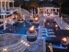 an aerial view of a mansion with pool and fire pit