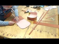 a woman is working on some crafting items with scissors and leathers in front of her