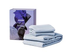 four folded sheets in front of a purple box and white background with the packaging on it