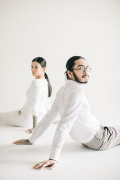 two people are doing yoga on the floor