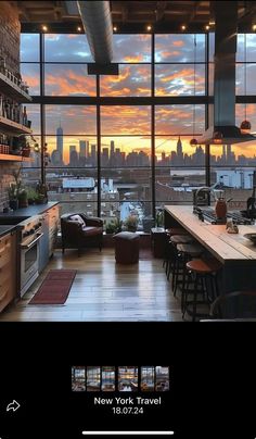 a kitchen with a large window overlooking the city at sunset or dawn, as seen from an apartment in new york