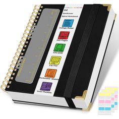 an open notebook with different colored papers on it