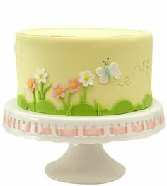 there is a cake with flowers and butterflies on it