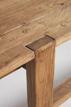 a close up of a wooden bench with no one around the table or in front of it