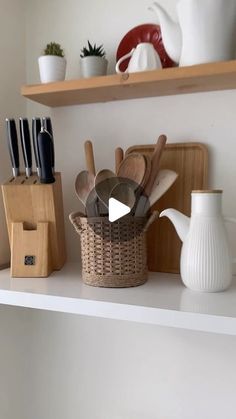 kitchen utensils in baskets on a shelf