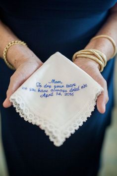 a woman holding a handkerchief with the words mom to dry your days