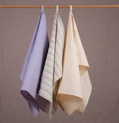 three folded towels hanging on a clothes line