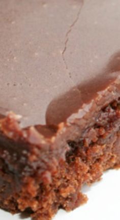 a piece of chocolate cake sitting on top of a white plate