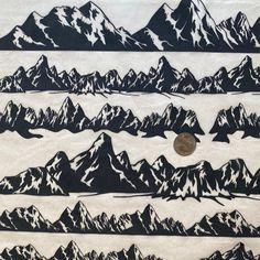 the mountains are black and white with a penny on it's bottom right side