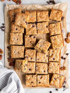 a tray full of granola bars on top of a table with nuts and chocolate chips