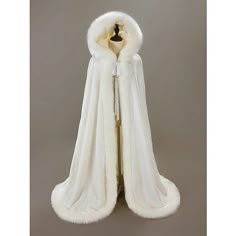 a white fur coat hanging on a hanger