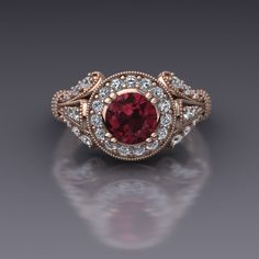 "A lovely and unusual two tone engagement ring. A round rhodolite garnet is set in a double prong rose gold head and surrounded by a halo of diamonds in this vintage style engagement ring in 14k white gold. The sides of the ring form a three-petaled shape reminiscent of a fleur-de-lis and scrolls line the side of the head. The top of the ring measures about 10mm at the widest point. A European shank balances the ring. Matching band available; price on request. Rhodolite Garnet Dimensions6mm Enha Lace Engagement Ring, Two Tone Engagement Ring, Two Tone Engagement Rings, Vintage Inspired Engagement Rings, Garnet Engagement Ring, Diamond Pendants Designs, Vintage Style Engagement Rings, Ring Matching, Edwardian Jewelry