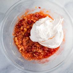 a bowl filled with some kind of food and sour cream on top of the mixture