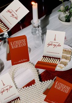 the table is set with matches, cards and other items to be used as favors