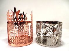 Add a touch of the tropics to your home décor with this Bath & Body Works 3-wick candle holder set featuring a copper pineapple and a silver pineapple and palm tree design. Perfect for all occasions, these medium-sized candle holders are a must-have for any contemporary style lover. Crafted from metal, this candle holder set is durable and long-lasting. The tropical pattern and subject make it a great addition to any decorative collection. Whether you're looking to add some ambiance to your living room or create a relaxing atmosphere in your bedroom, these candle holders are the perfect choice.  There is a small scratch on the copper candle holder - see photo. Copper Candle Holder, Copper Candle, Palm Tree Design, Relaxing Atmosphere, 3 Wick Candles, Wick Candle, Candle Holder Set, Tropical Pattern, Tree Design