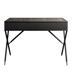 a black table with metal legs and a glass top