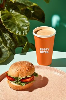 a burger and cup of coffee on a table