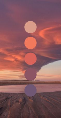 five circles are arranged in the shape of a pyramid on top of a beach at sunset