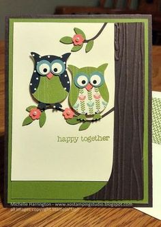 two owls sitting on top of a tree branch with the words happy together written on it