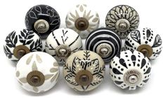 an assortment of black and white ceramic knobs with designs on the front, back and sides