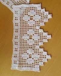 a piece of white crocheted cloth with holes in it on a table top