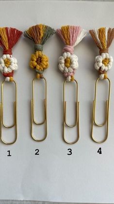 four different types of paper clips with flowers on them and numbers in the bottom row