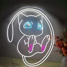 a neon sign with an image of a cat in the middle and flowers on the side