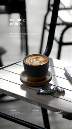 a cup of coffee sitting on top of a wooden table