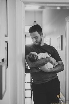 a man holding a baby in his arms